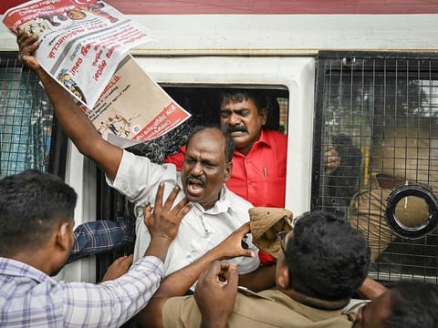 Police personnel detain a member of the Communist Party of India (CPI-M) during a protest against India's Prime Minister Narendra Modi and billionaire businessman Gautam Adani, calling for the tycoon's arrest over corruption allegations by US prosecutors, in Chennai on November 23, 2024.