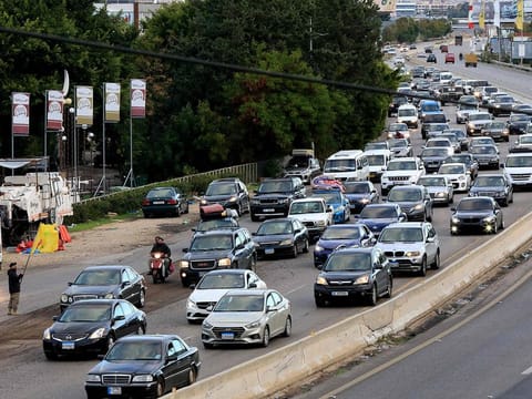People drive on the highway between Sidon and Tyre on November 27, 2024, as displaced people make their way back to their homes in the south of Lebanon after a ceasefire between Israel and Hezbollah took effect.