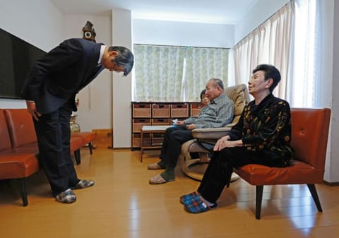Hideo Yamada, chief prosecutor of the Shizuoka District Public Prosecutors Office, bows to apologise to Iwao Hakamada after his acquittal was confirmed in a retrial in October, as his sister Hideko Hakamada looks on, in the city of Hamamatsu, Shizuoka prefecture on November 27, 2024.