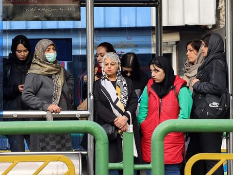 People wait for the bus in Tehran. File photo.