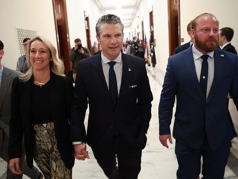 US President-elect Donald Trump's nominee to be Secretary of Defence Pete Hegseth (centre) arrives for a meeting with US Senator Joni Ernst (R-IA) at the US Capitol on December 4, 2024 in Washington, DC.