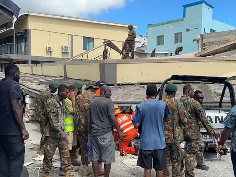 This screengrab taken from handout video footage posted on the Facebook account of Michael Thompson on December 17, 2024 shows security forces and rescuers inspecting a damaged car trapped underneath a collapsed building in Vanuatu's capital Port Vila after a powerful earthquake hit the Pacific island.