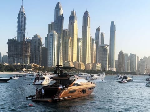 At Dubai Marina Beach, boats and yachts glide smoothly through the crystal-clear waters, offering a perfect setting for a leisurely cruise.