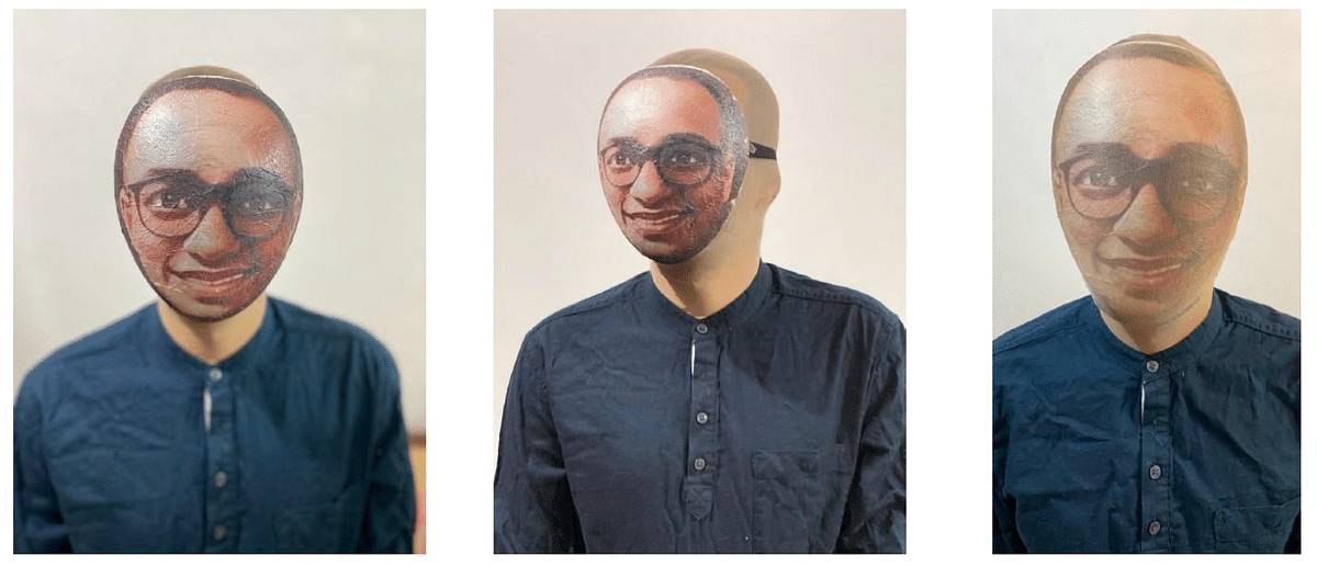 Cardboard masks with Mehta's face printed