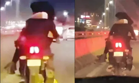காதலியை மடியில் உட்கார வைத்து மோட்டார் சைக்கிள் ஓட்டிய வாலிபர் - வீடியோ வைரல்