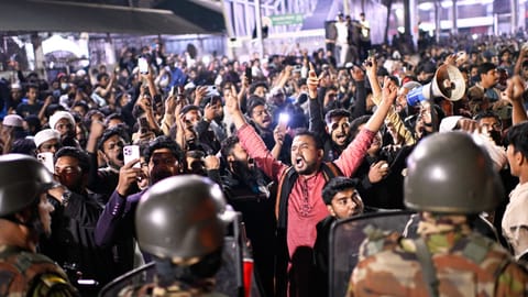 Protesters shout slogans in front of the premises of the Prothom Alo newspaper after news reached the country from Singapore of the death of a prominent activist Sharif Osman Hadi, in Dhaka, Bangladesh, Friday, Dec. 19, 2025. 