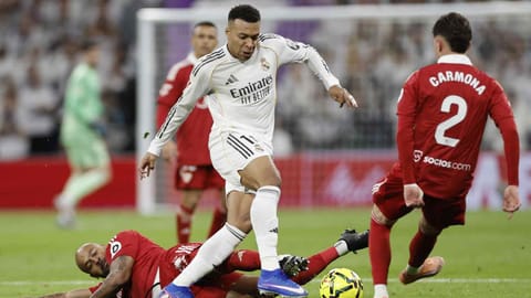 Kylian Mbappe controls the ball as defender Marcao Teixeira and Jose Carmona tackle him 