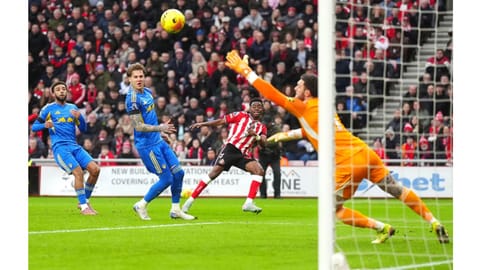 Sunderland's Simon Adingra, center, scores their side's first goal of the game past Leeds United goalkeeper Lucas Perri during the English Premier League soccer
match in Sunderland, England.