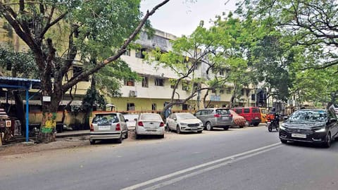 Vehicles parked on the streets, especially right outside the compound walls of apartments in Anna Nagar