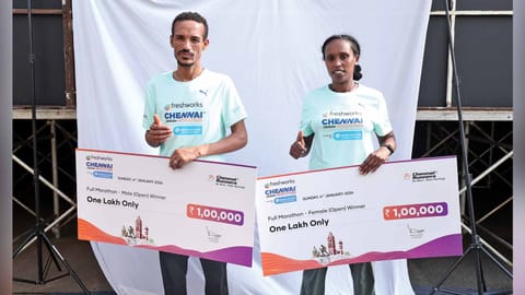 Tsegaye Molla, Senait Kefelegn Lesharge with their cheques