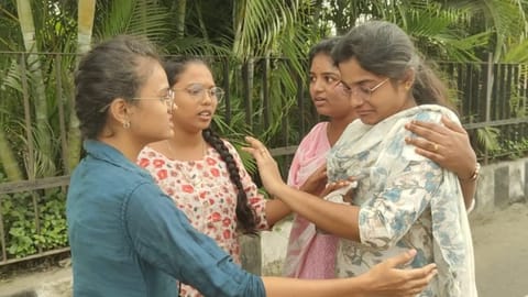 The woman (in white Churidar) is being consoled by friends