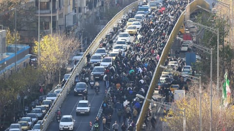 Protesters march on a bridge in Tehran, Iran