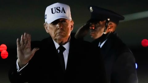 President Donald Trump waves after arriving on Air Force One from Florida