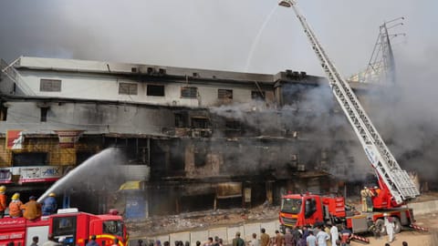 Firefighters try to control a massive fire that was broke out in a multi-story shopping mall in overnight, in Karachi, Pakistan