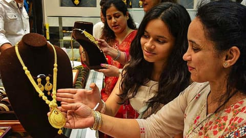 Image of woman buying gold used for representative purpose