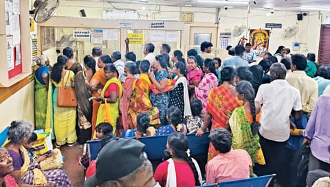 Women line up at a bank in Theni to withdraw the KMUT money