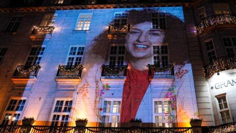 Nobel Peace Prize recipient Narges Mohammadi is projected on the wall of the Grand Hotel in central Oslo before the Nobel banquet
