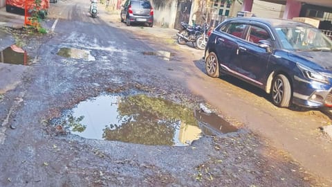 Sewage water-filled damaged Veerapandiya Kattabomman Road