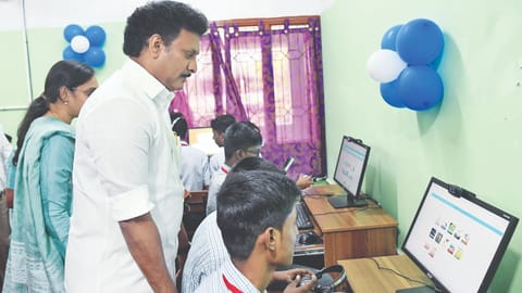 Minister Poyyamozhi listening a student explain the function of a high-tech lab on Friday