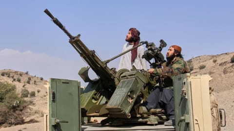 Taliban fighters look up while manning an armed pickup truck at the Afghan side of the Ghulam Khan crossing with Pakistan in Khost province, Afghanistan, Friday, Feb. 27, 2026. 