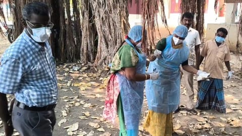 Officials examine the carcasses of birds lying dead mysteriously in Namakkal 