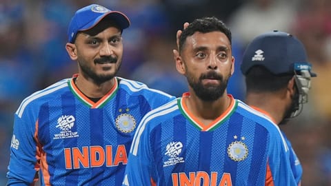 Spectators cheer as India's Varun Chakravarthy celebrates after dismissing England's Jos Buttler during the ICC Men's T20 World Cup 2026 second semifinal cricket match between India and England at Wankhede Stadium, in Mumbai, Thursday, March 5, 2026
