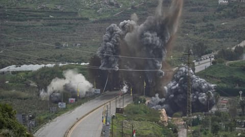 Smoke and debris rise from an Israeli airstrike that hit the Qasmiyeh Bridge near the coastal city of Tyre, Lebanon
