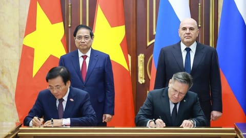 Vietnamese Prime Minister Pham Minh Chinh, standing left and Russian Prime Minister Mikhail Mishustin, standing right, witness a signing ceremony of agreements during Chinh's official visit in Moscow, Russia.
