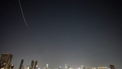 Missiles launched from Iran streak across the sky over central Israel, early Tuesday, March 24, 2026.
