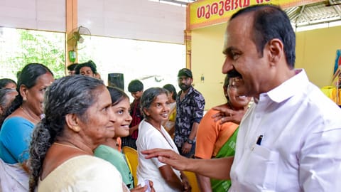 Leader of the Opposition and UDF candidate from Paravur constituency VD Satheesan interacts with residents during an election campaign, in Kochi, Sunday, March 22, 2026 