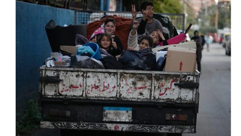 Displaced children sit on a truck with their packed belongings as they wait for an official ceasefire decision between Iran and the United States that they hope will include Lebanon and allow them to return to their villages, in the southern port city of Sidon, Lebanon, Wednesday, April 8, 2026 