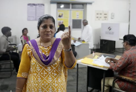 People show their ink-marked fingers after casting votes during the Puducherry Assembly elections, at a polling station in Puducherry, Thursday, April 9, 2026.