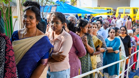 People wait in a queue to cast votes during the Kerala Assembly elections, at a polling station, in Thiruvananthapuram, Thursday, April 9, 2026 