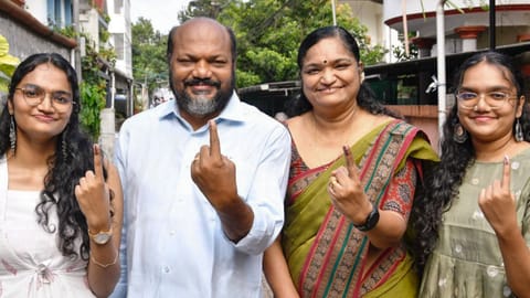 LDF candidate P Rajeev, second left, and his family members show their ink-marked fingers after casting votes during the Kerala Assembly elections, in Ernakulam district, Thursday, April 9, 2026 