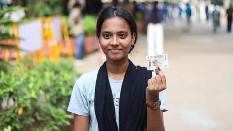 A first-time voter is thrilled after getting inked