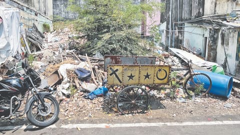 Uncleared construction debris piled up between housing board flats at Boopathy Nagar in Kodambakkam 