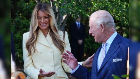 First lady Melania Trump and Britain’s King Charles III talk during a tour of the White House garden and bee hive on the South Lawn of the White House