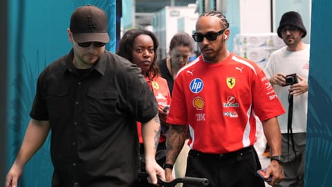 Ferrari driver Lewis Hamilton, center right, of Britain, leaves a hospitality tent after speaking to the press, Thursday, April 30, 2026, in Miami Gardens, Fla., ahead of the Formula One Miami Grand Prix auto race