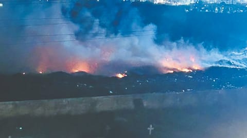 Smoke billowing from the garbage mound on fire in Cheran Nagar near Perumbakkam