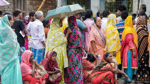 South 24 Parganas: Voters wait in queues to cast thir votes at a polling station during a repoll 