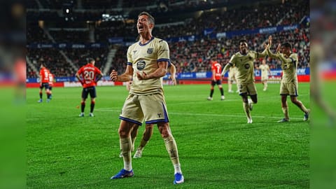 Barcelona's Robert Lewandowski celebrates after scoring his side's opening goal during a Spanish La Liga soccer match between Osasuna and Barcelona in Pamplona, Spain