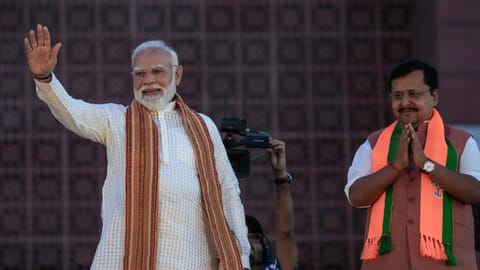 Prime Minister Narendra Modi waves to the gathering during an event celebrating the party's performance in Assembly elections across four states and one union territory, at the party headquarters in New Delhi
