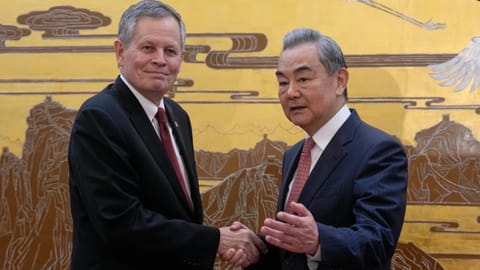 US Senator Steve Daines, left, is greeted by Chinese Foreign Minister Wang Yi during a US congressional delegation visit at the Great Hall of the People, in Beijing