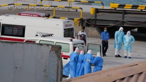 Health workers in protective gear evacuate patients from the MV Hondius cruise ship at a port in Praia, Cape Verde