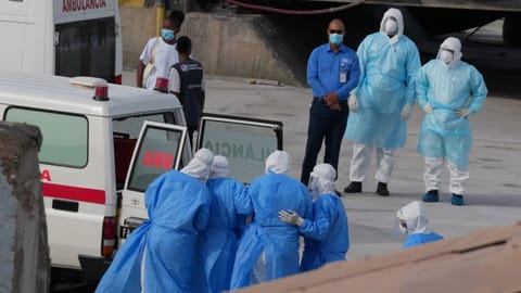 Health workers in protective gear evacuate patients from the MV Hondius cruise ship into an ambulance at a port in Praia, Cape Verde