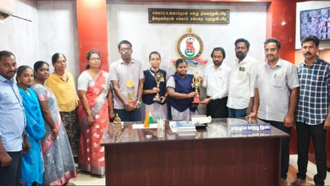 Secretary of Sambavika Higher Secondary School in Sivaganga felicitates third-ranked Akshaya and other achievers on Friday