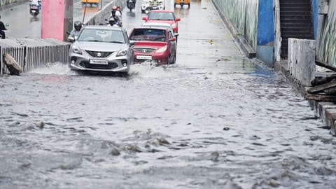 Motorists navigate stagnated Melapudur bridge in a risky manner in Tiruchy on Saturday