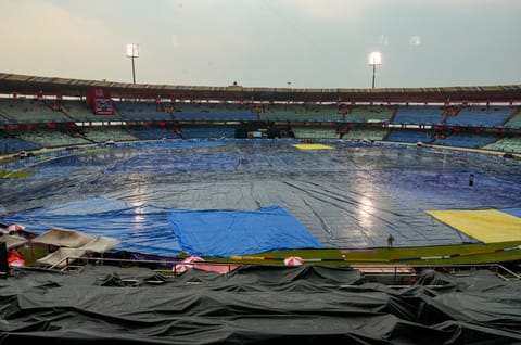 The ground remains covered amid rainfall before an Indian Premier League (IPL) 2026 T20 cricket match between Royal Challengers Bengaluru and Kolkata Knight Riders, in Raipur, Chhattisgarh, Wednesday, May 13, 2026