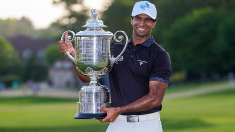 Aaron Rai, of England, holds the Wanamaker Trophy after winning the PGA Championship golf tournament at Aronimink Golf Club