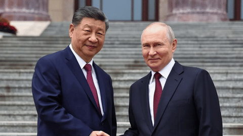 Russian President Vladimir Putin, right, and Chinese President Xi Jinping shake hands during a welcome ceremony at the Great Hall of the People, in Beijing, China